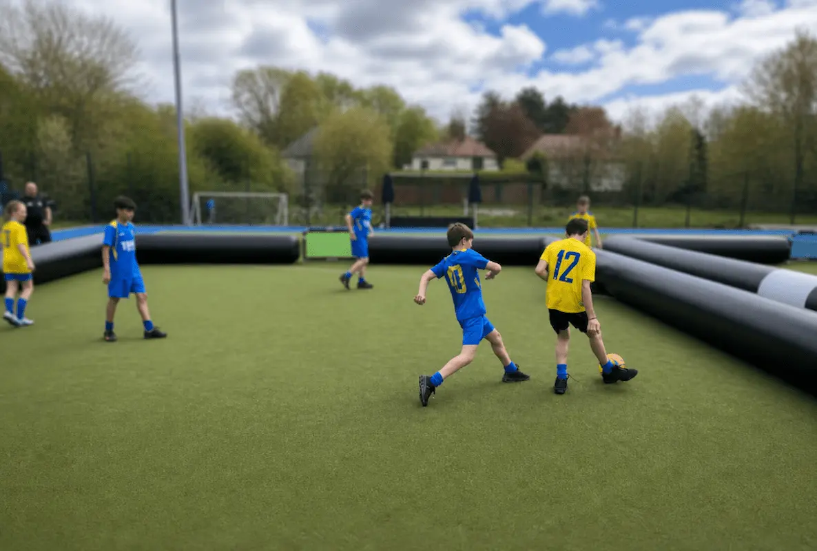 Customers using an AirPitchPro inflatable football arena at an outdoor event
